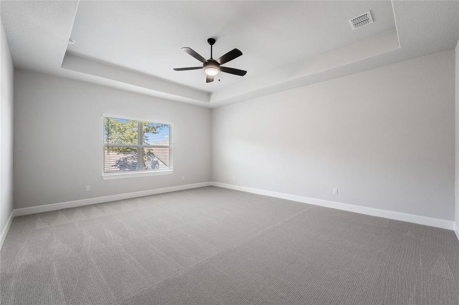 Spacious Master Bedroom with carpet, ceiling fan, and double window.