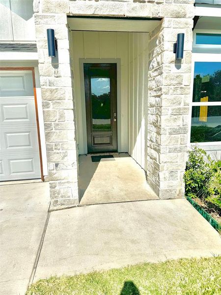 Doorway to property with a garage