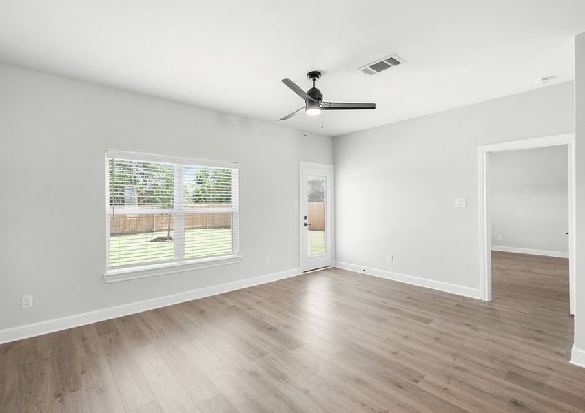 The family room of the Driftwood has a large window that lets in great, natural light and backyard views.