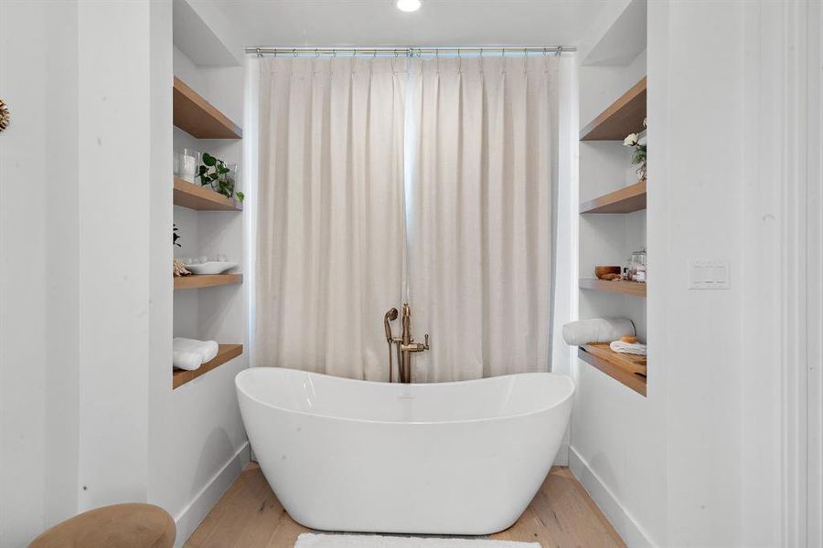 Bathroom with built in features and hardwood / wood-style floors