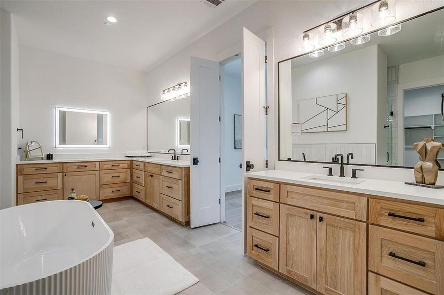 Bathroom featuring vanity and shower with separate bathtub