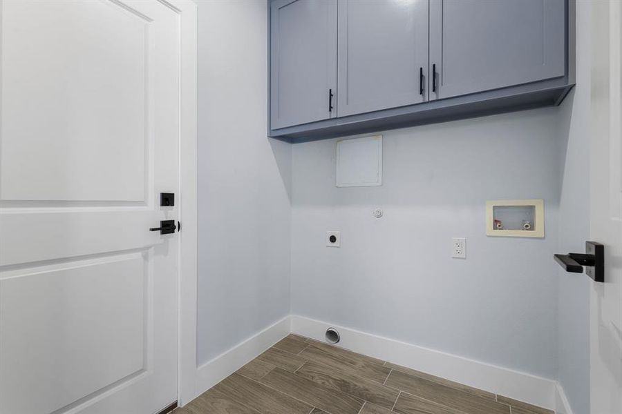 Laundry room with wood-type flooring, cabinets, hookup for a washing machine, and electric dryer hookup