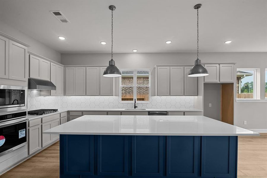 EXAMPLE PHOTO: Separate oven/micro, gas c-top with updraft vent hood in a cabinet and quartz counters. Cabinets on back of island too!