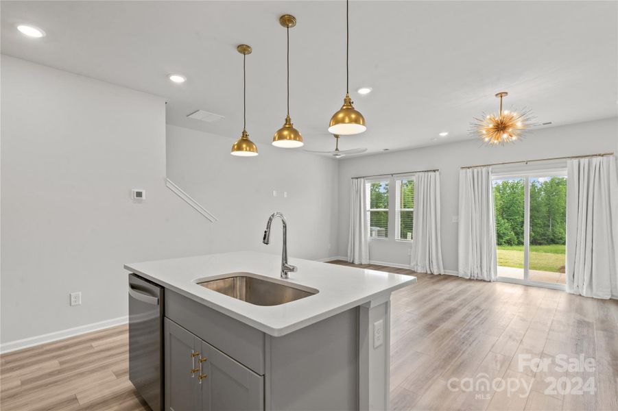 kitchen island with sink and upgraded pendant lighting