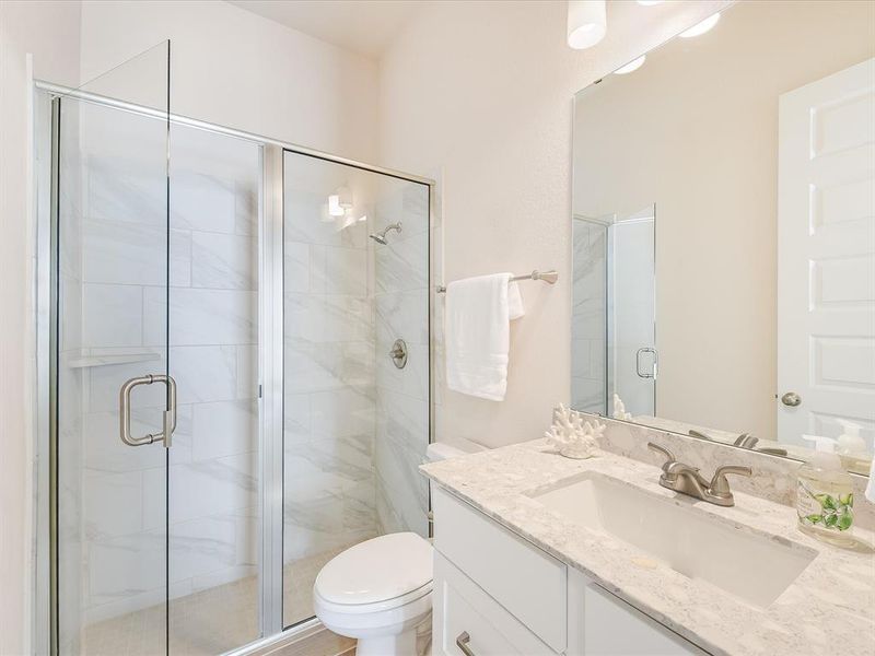 Beautiful en suite bath with walk-in shower in one of the secondary bedrooms.