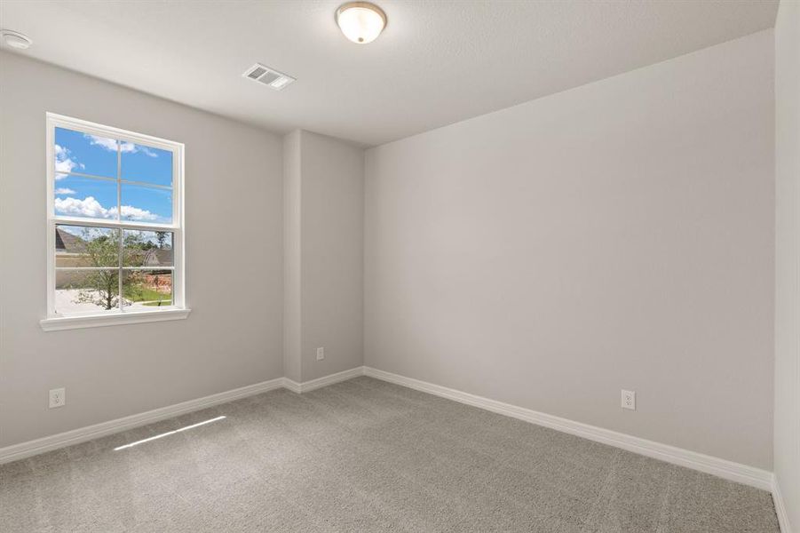 Your secondary bedroom features plush carpet, fresh paint, closet, and a large window that lets in plenty of natural lighting.