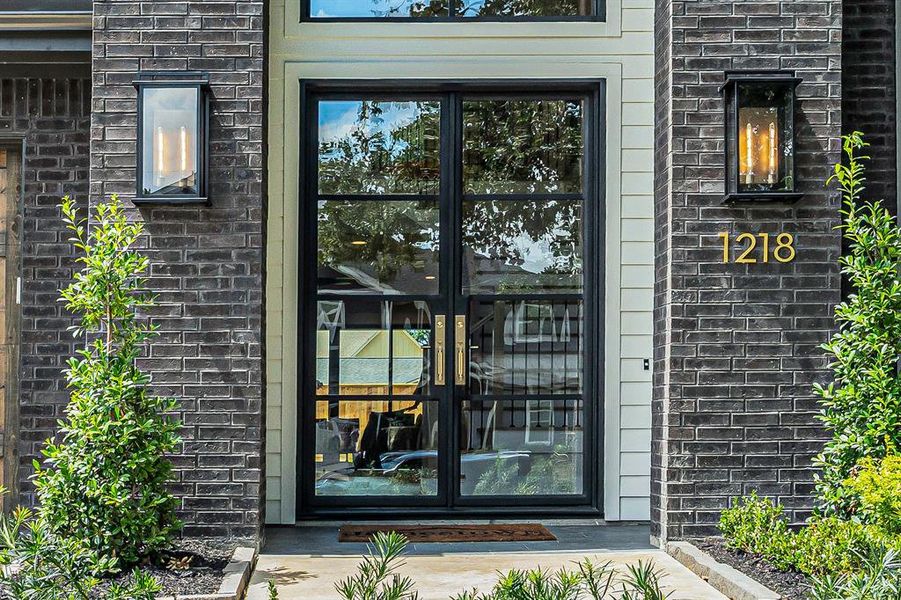 Double iron and glass front doors create an imposing first impression when you walk up to the home.