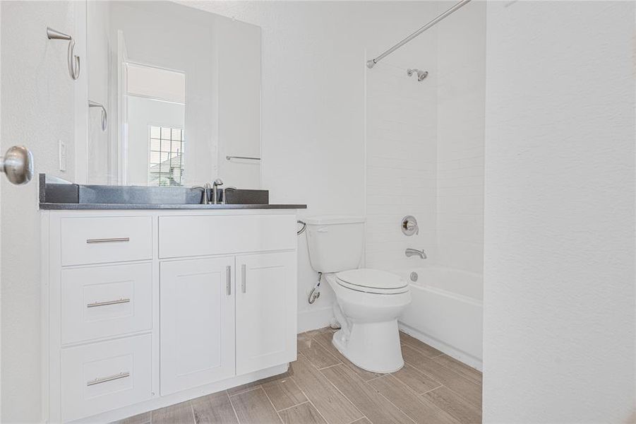 Step into the secondary bathroom of this well-appointed home, where functionality meets style in a space designed for comfort and convenience.