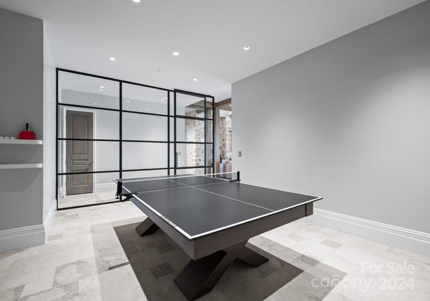 A stunning architectural grid patterned wall with glass and a custom-made ping pong table.