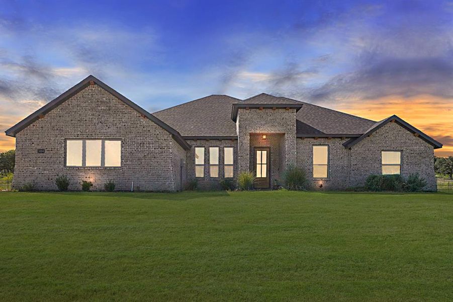 View of front of home featuring a yard