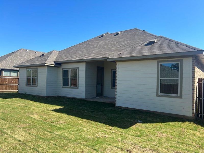 Rear view of house with a yard