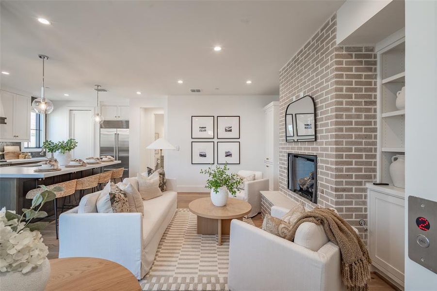 Living room with a fireplace and light wood flooring