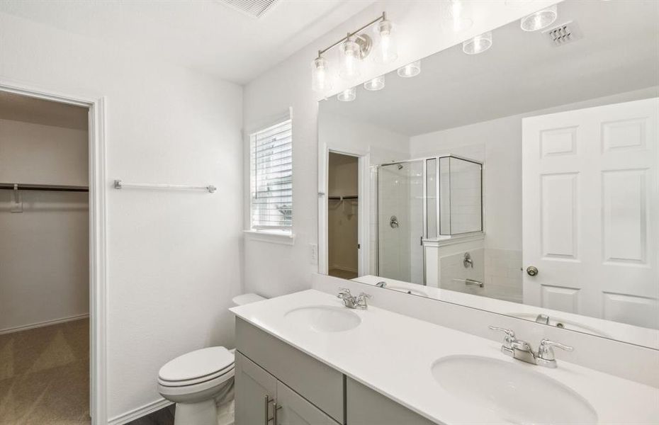 Spacious owner's suite with dual vanity *real home pictured