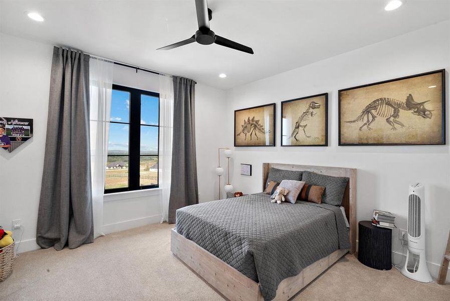 Bedroom featuring light carpet and ceiling fan