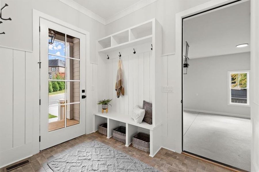 Mudroom with a wealth of natural light and ornamental molding