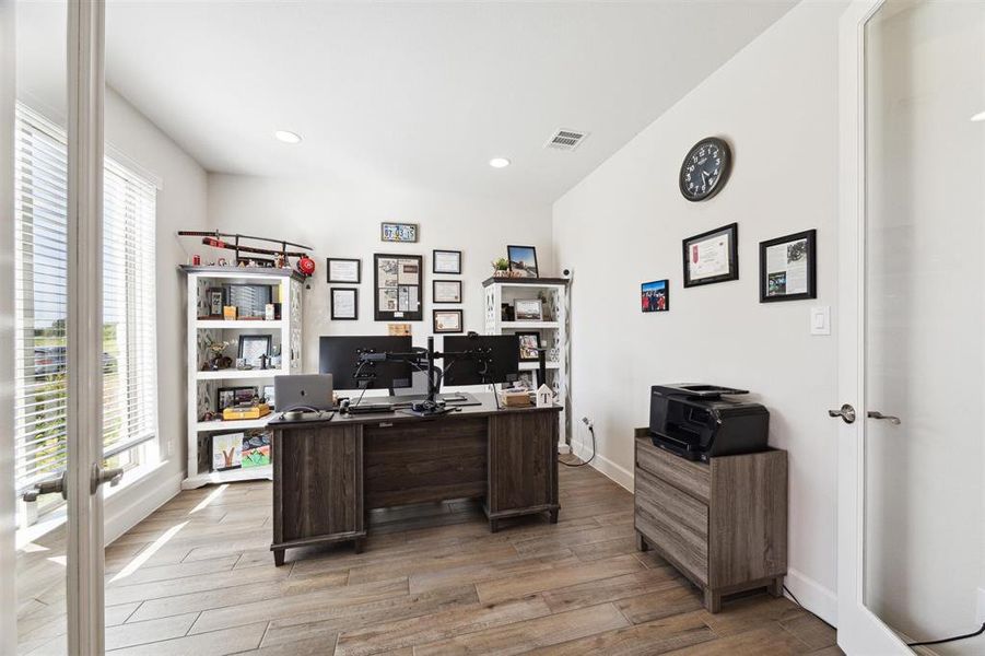 The home office/study is located at the left of the entry and features French door access, tile flooring, recessed lighting and a large window overlooking the front lawn.