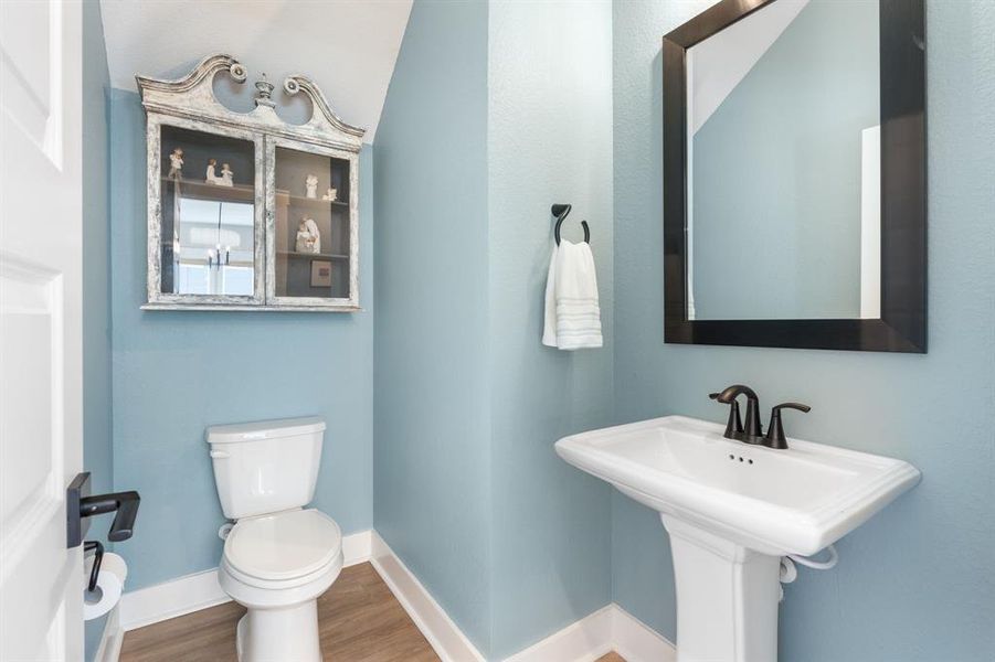 Powder room located on the first floor. Cabinet will not stay with the home.