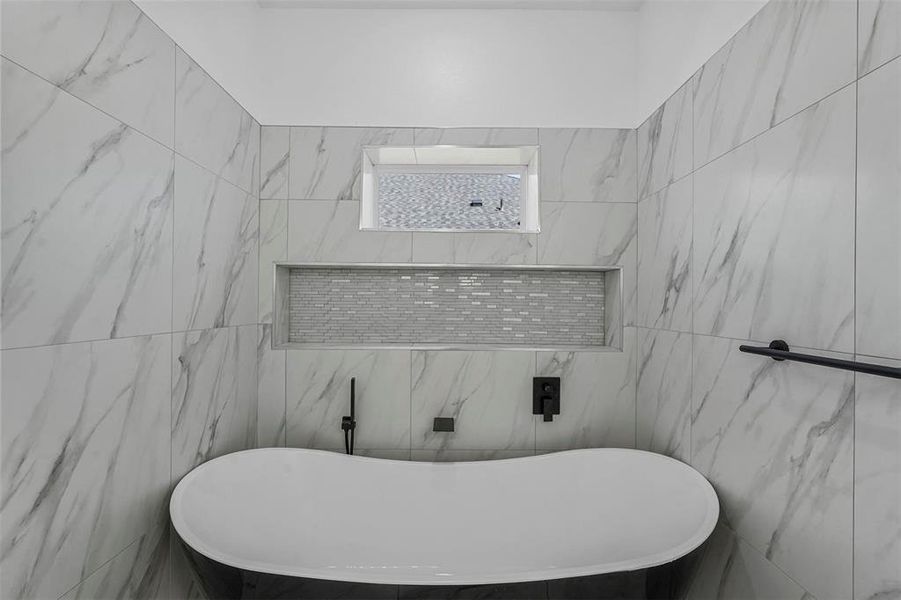 Bathroom with tile walls and a washtub