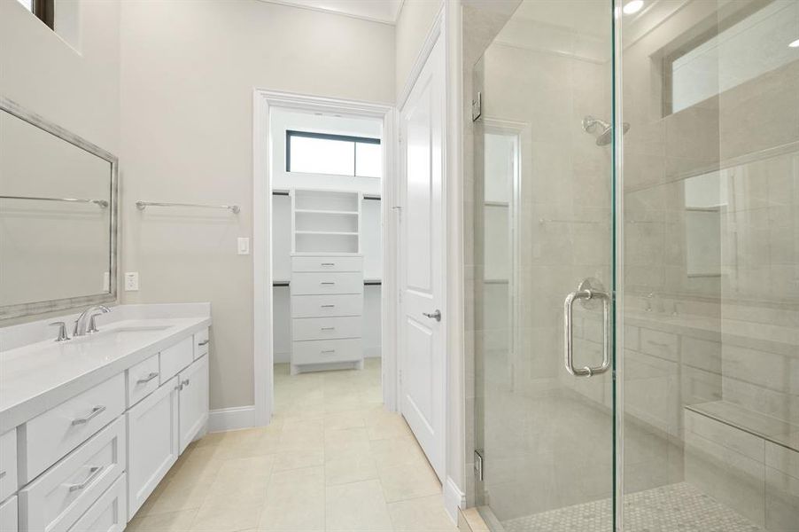 This master bathroom is definitely move-in ready! Featuring a walk-in shower, and light color cabinets with separate vanities.
