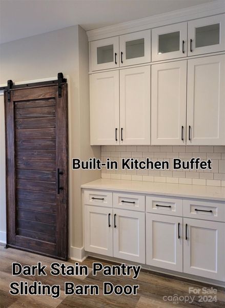 Sample pic from another build - Built in Buffet in Kitchen with Glass top cabinets NOTE** Barn Doors are ana additional charge - Regular Door is Standard in Build.