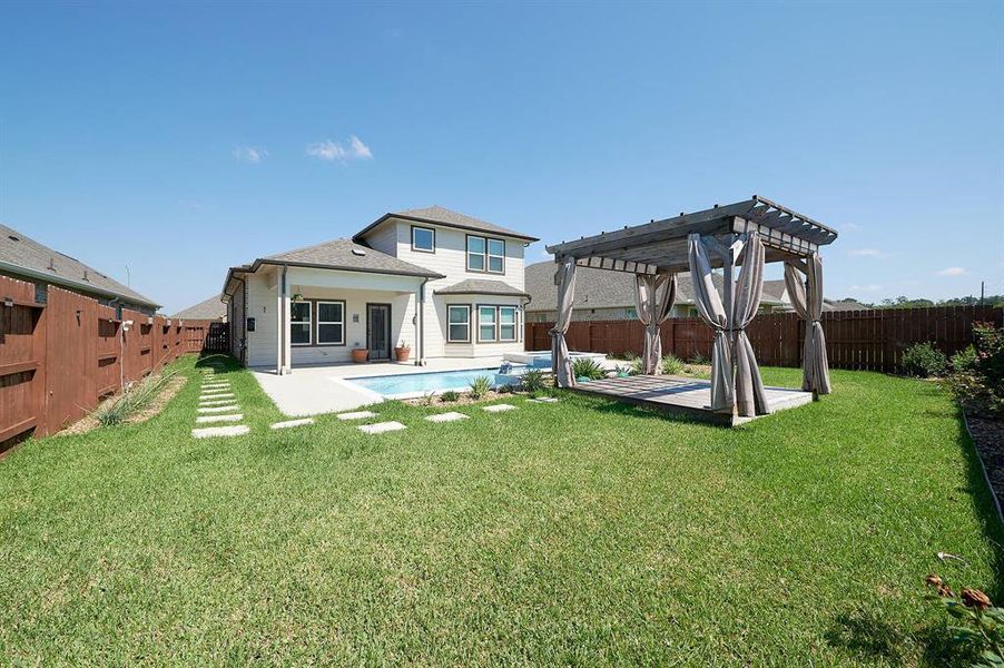 Landscaped backyard with Pergola.