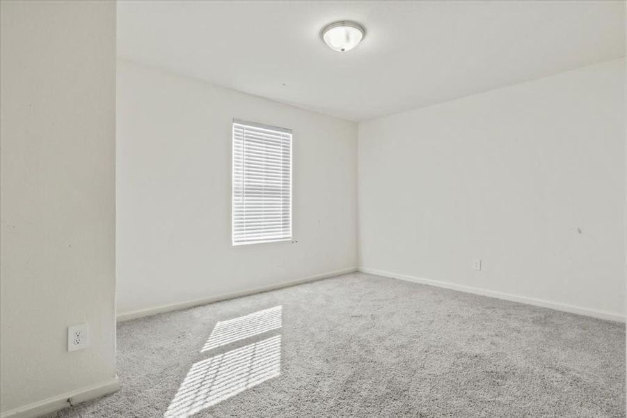 Unfurnished room featuring light colored carpet