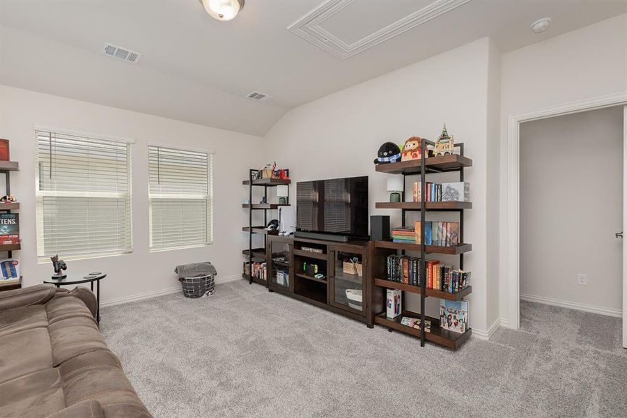 Living room featuring light carpet and vaulted ceiling