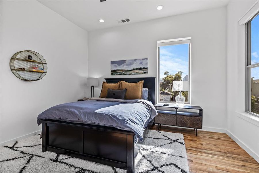 Primary Bedroom with wood flooring