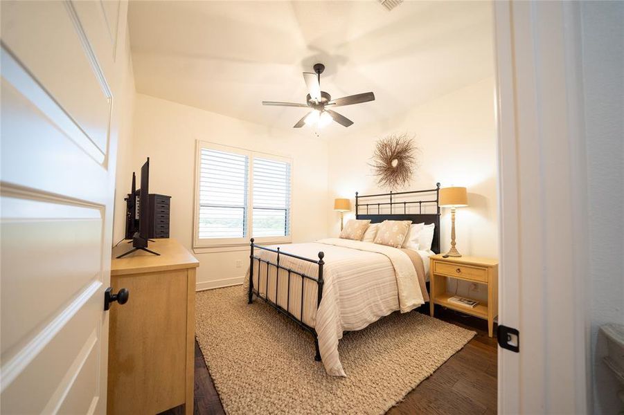 Bedroom with ceiling fan and dark hardwood / wood-style flooring