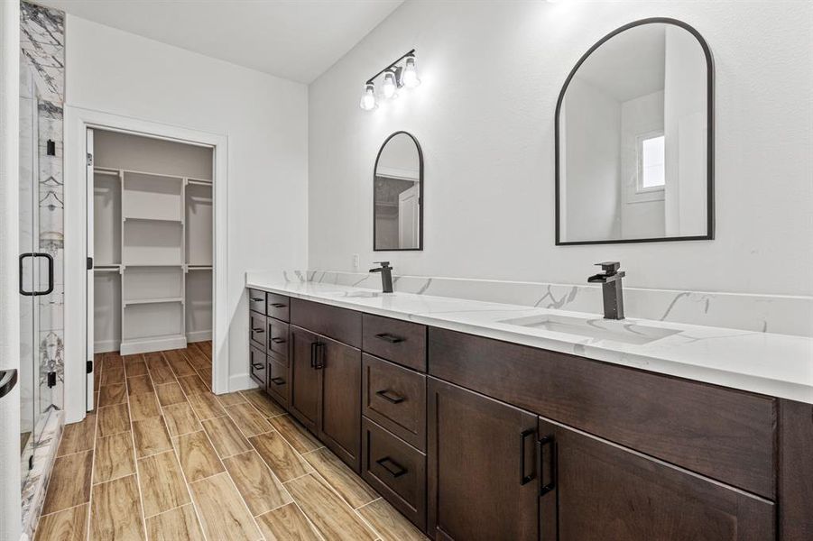 Bathroom featuring hardwood / wood-style floors and double sink vanity