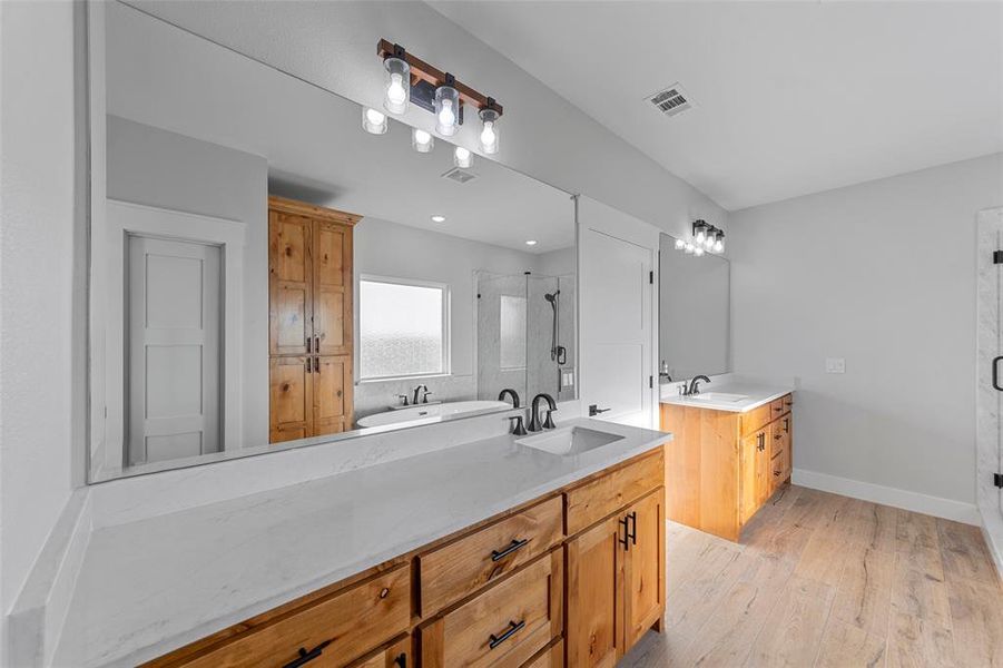 Bathroom with separate shower and tub, hardwood / wood-style flooring, and dual bowl vanity