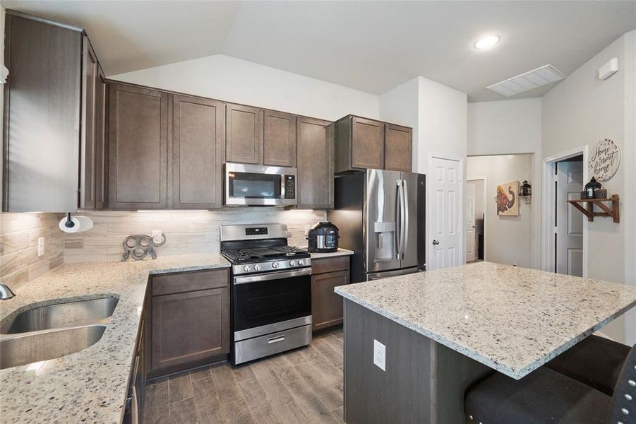 42" upper cabinets with undercabinet lighting give this kitchen a homey feel!