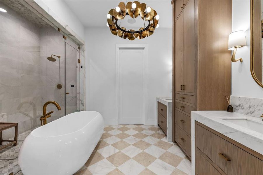 Bathroom featuring vanity and shower with separate bathtub