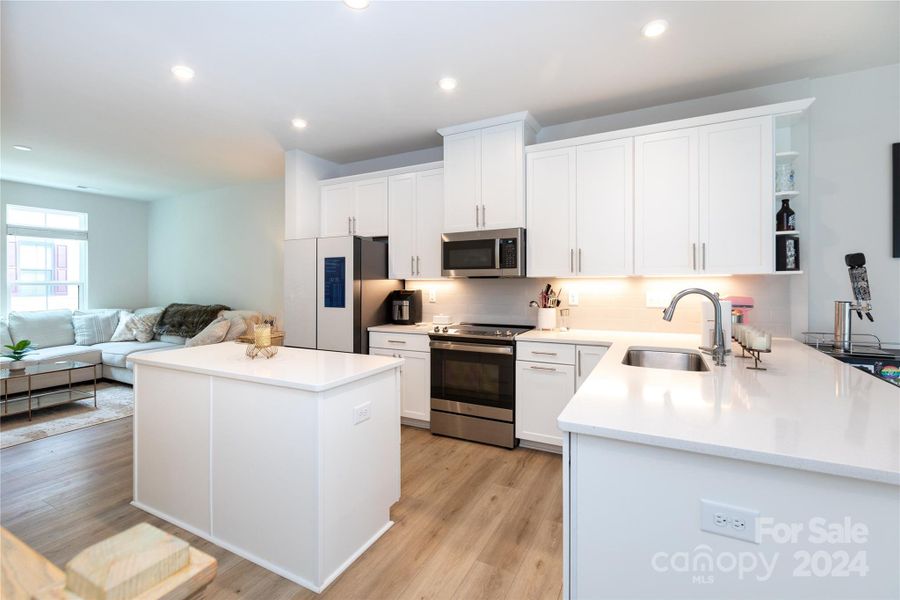 Clean lines and new appliances await in the kitchen with upgrade under-cabinet lighting.