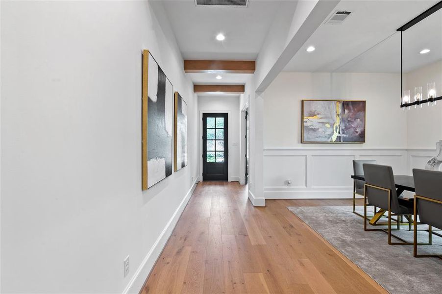 Step into elegance with the rich, warm tones of the luxury engineered wood flooring gracing this inviting entryway.