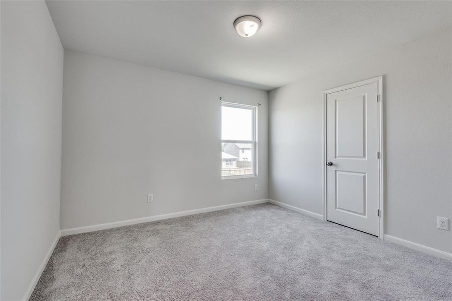 Spare room featuring light carpet