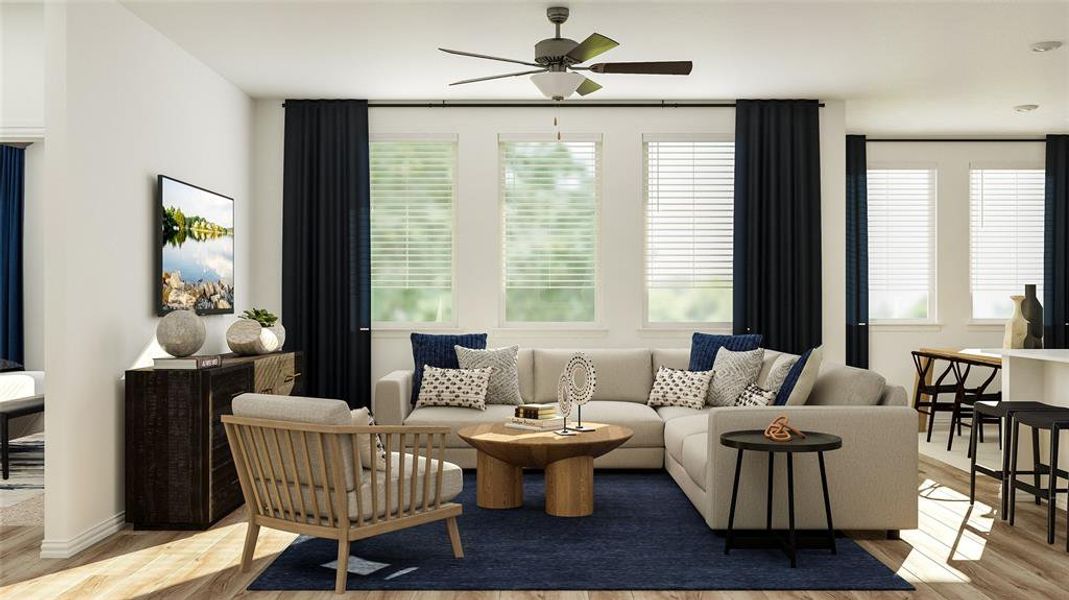 Living room with a healthy amount of sunlight, ceiling fan, and hardwood / wood-style floors