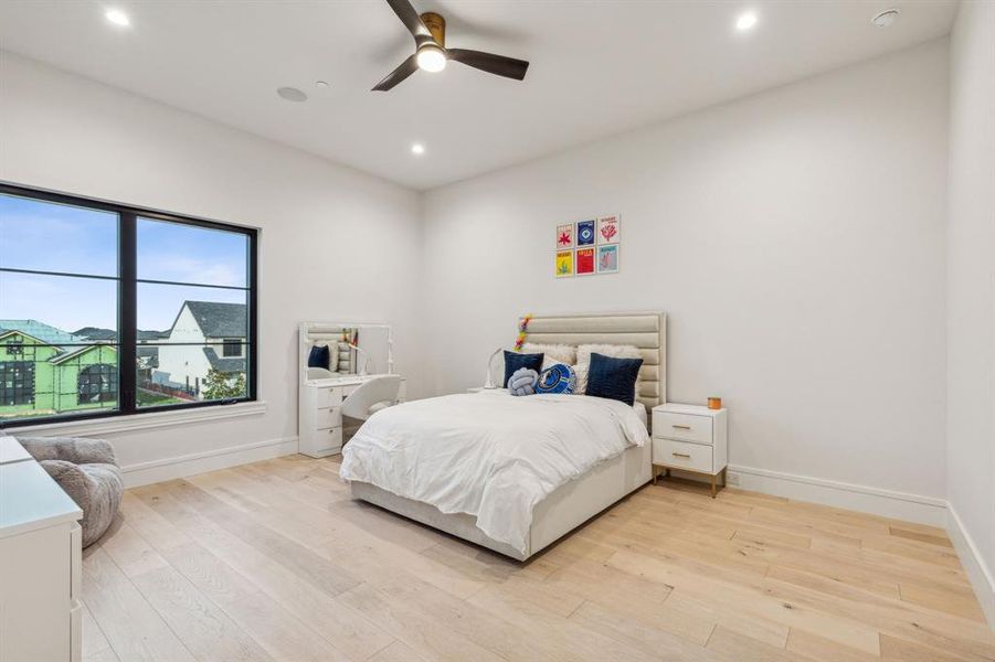 Bedroom with light hardwood / wood-style flooring and ceiling fan