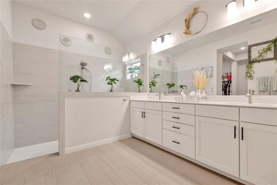 Luxurious Ensuite Bathroom - Double sinks, extended shower, beautiful fixtures, and cabinetry. Light, bright, and complete with a large walk-in closet