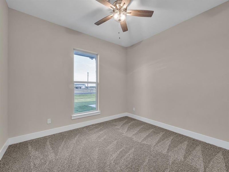 Empty room with carpet floors and ceiling fan