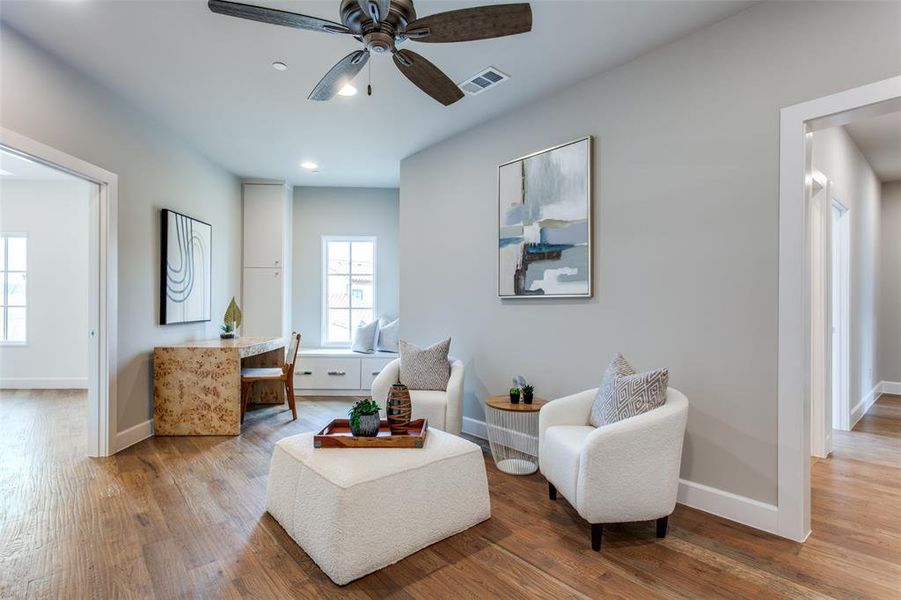 Sitting room featuring hardwood / wood-style flooring and ceiling fan