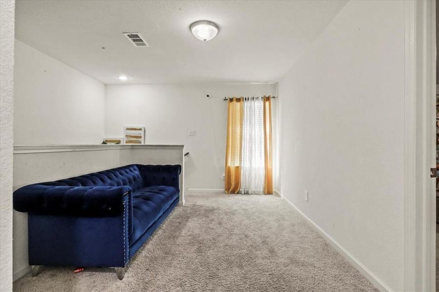 Sitting room featuring carpet flooring