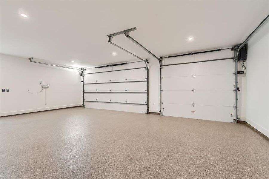 The THREE-CAR garage is luxurious in its own right, with spray-foam insulation, high-end openers and flooring, and an electric car charging port.