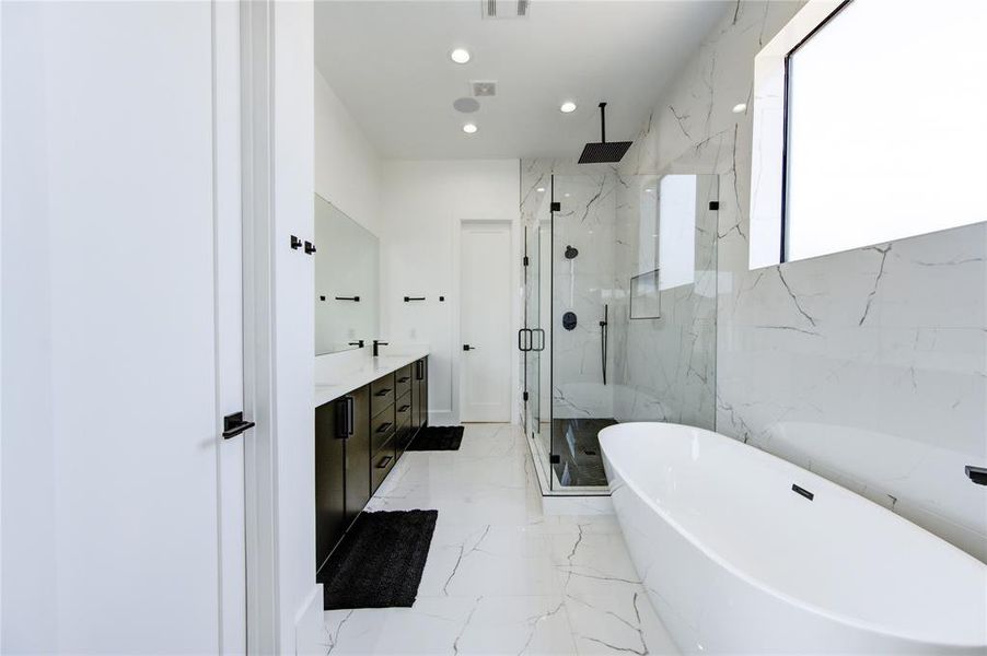 Primary bathroom has double sinks, oversized standup shower and a nice soak-in tub