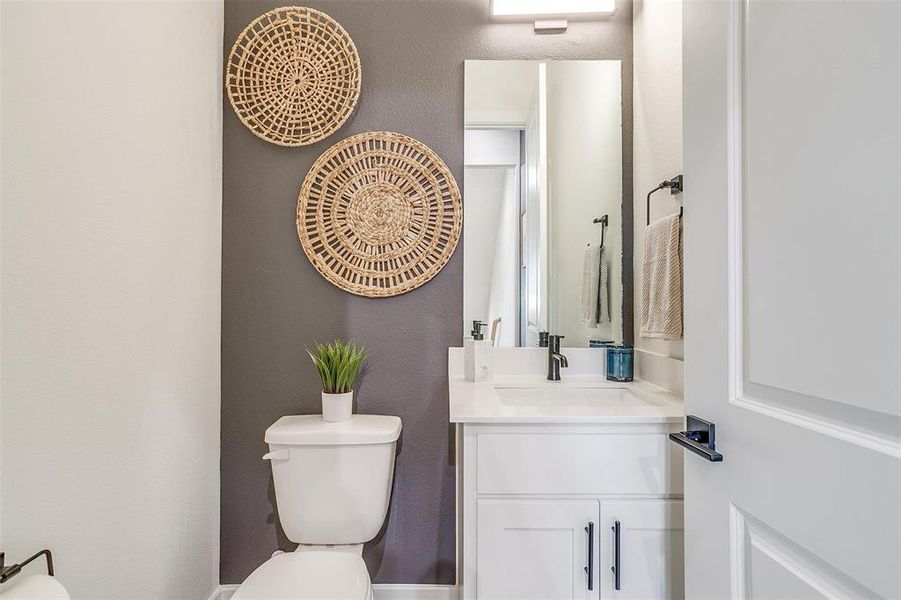 The stylish powder bath features modern fixtures and elegant design elements, creating a chic and functional space for guests. With its attention to detail and sophisticated ambiance, it adds a touch of luxury to your home's interior.