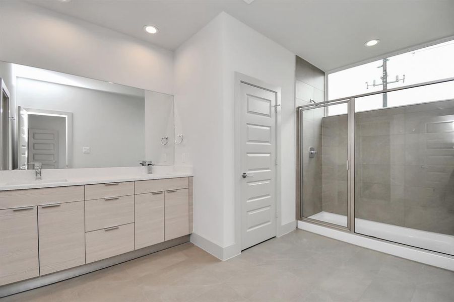 Spacious and spa-like primary bathroom suite