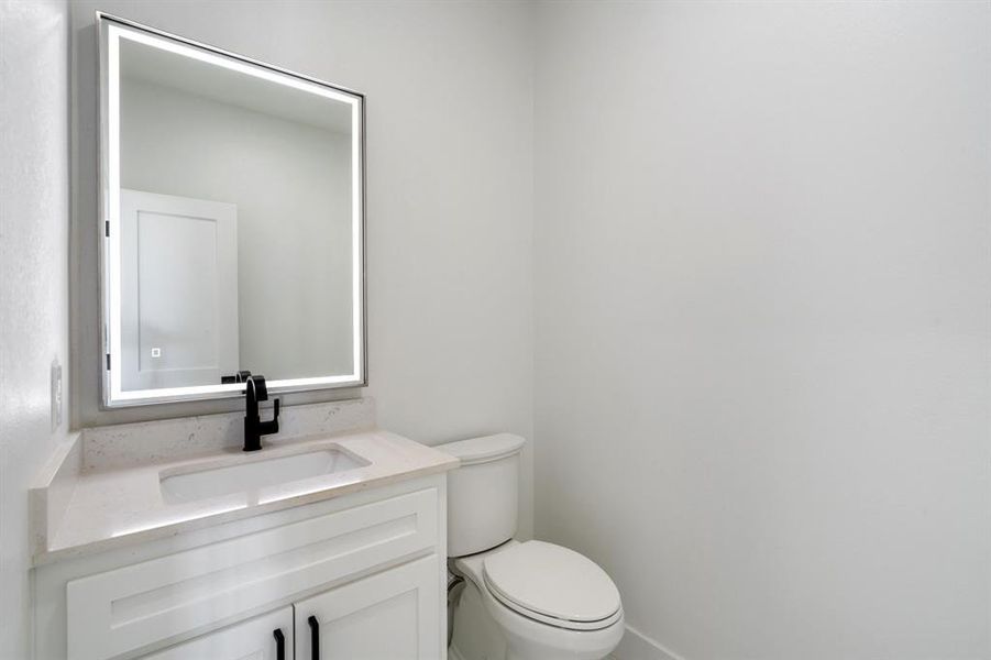 Bathroom featuring vanity and toilet