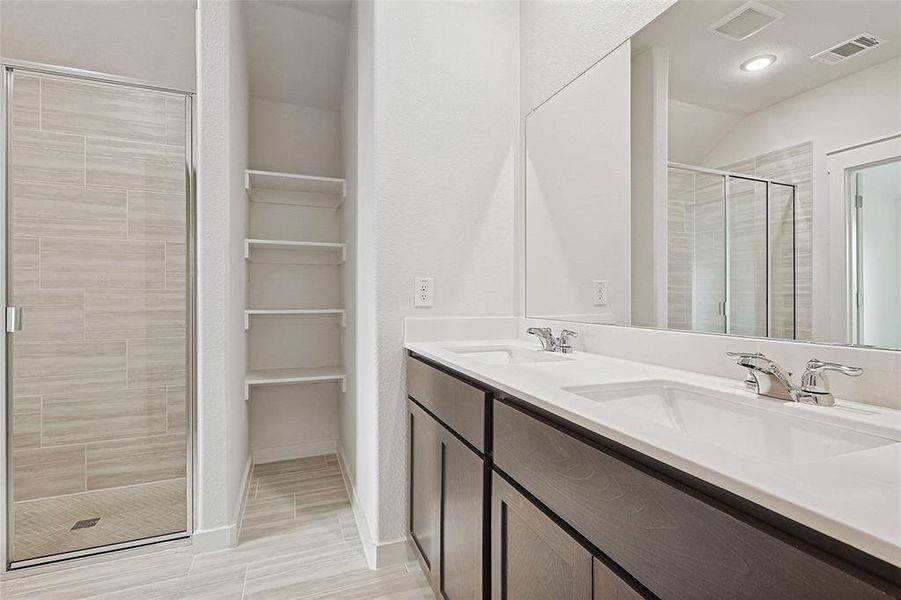 Bathroom featuring vanity, hardwood / wood-style flooring, and walk in shower