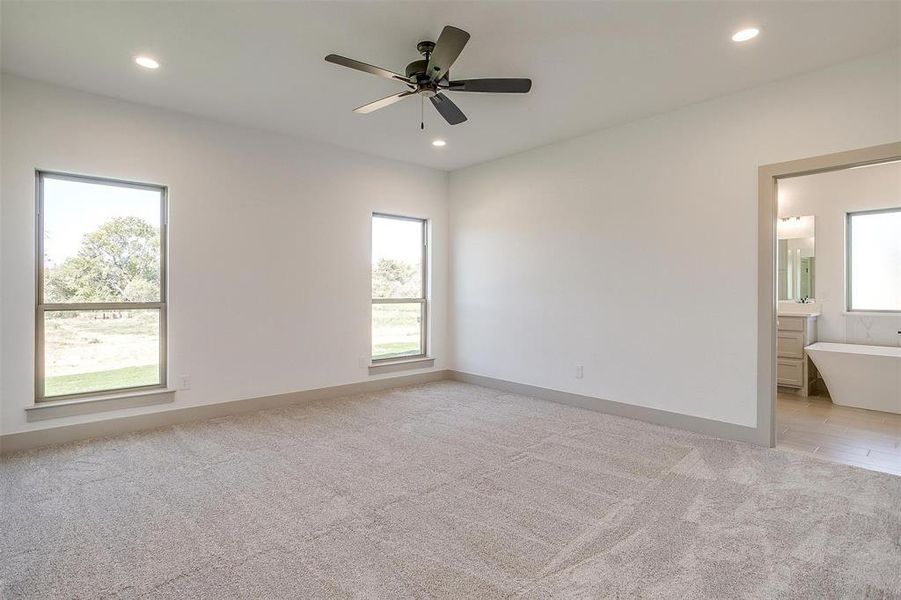 Carpeted empty room with ceiling fan