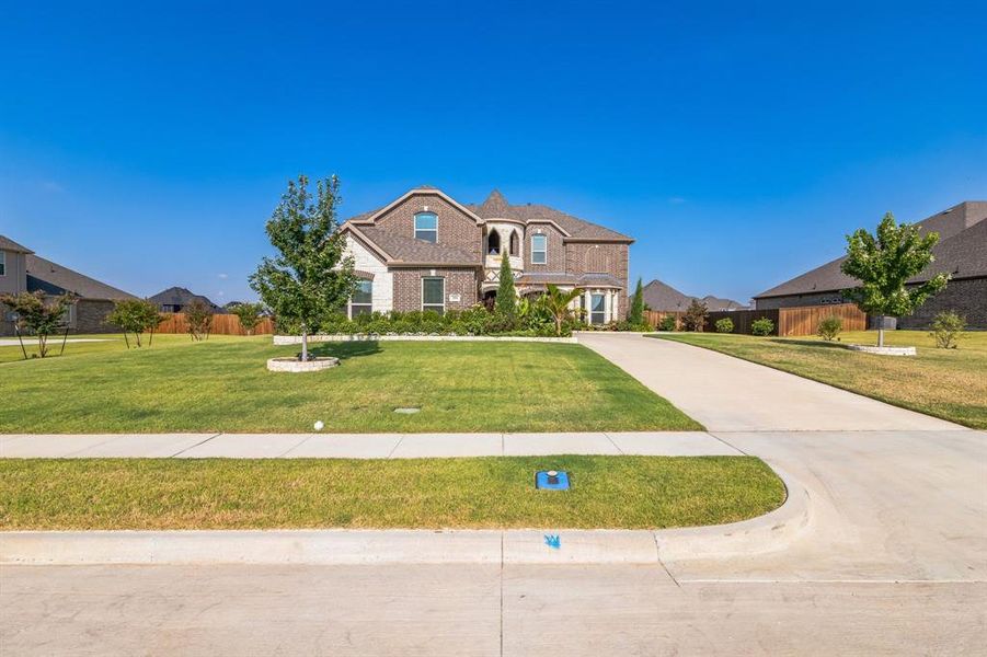 French provincial home featuring a front yard